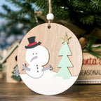 Hand-painted wooden Christmas pendant with elk design displayed against festive background