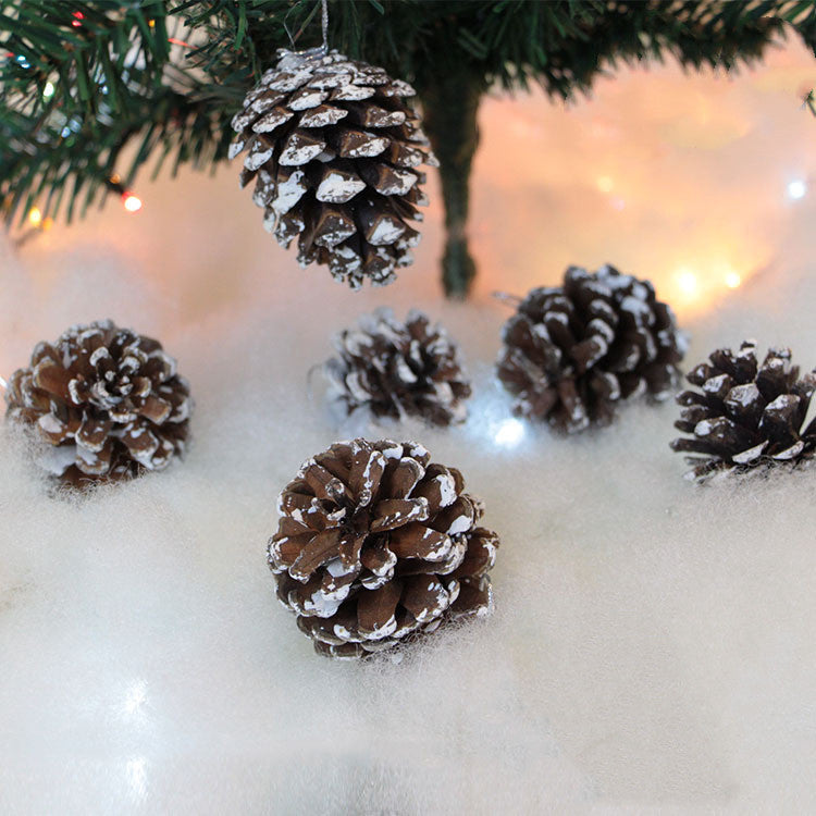 Christmas tree decorated with pine cone ornaments and golden lights