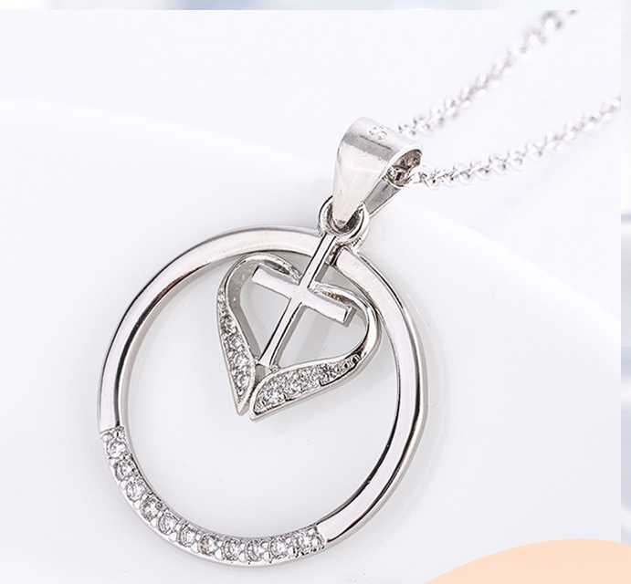 Elegant Jesus cross pendant with heart motif in polished silver finish