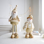 Detailed view of golden snowman ornament with Christmas elements