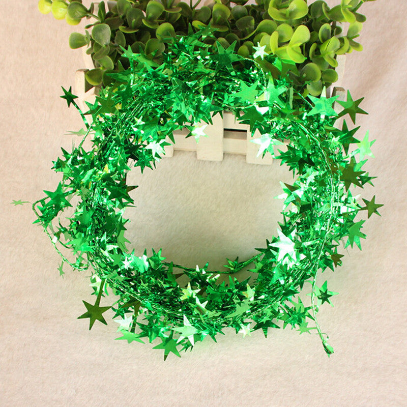 Festive pine garland with hanging stars for Christmas tree decoration