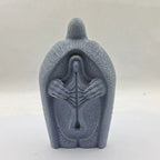 Close-up of hand-painted detail on resin Jesus ornament with serene expression