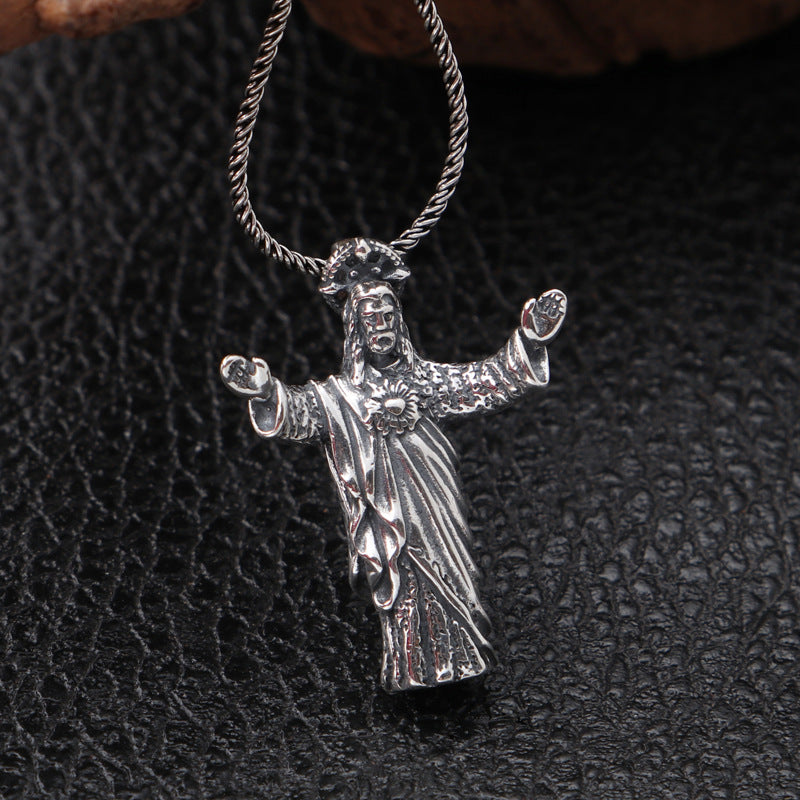 Front view of vintage distressed sterling silver Jesus pendant with antique finish