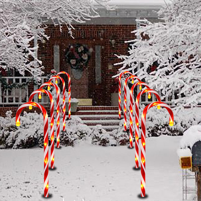 Snowflake garden lights illuminating lawn during Christmas evening