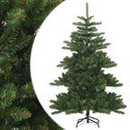 Fully decorated Christmas tree with ornaments and lights in a festive home setting