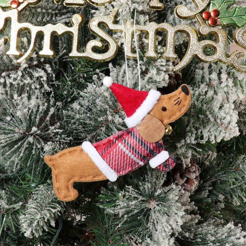 Close-up of dressed sausage dog pendant in warm brown non-woven fabric for Christmas