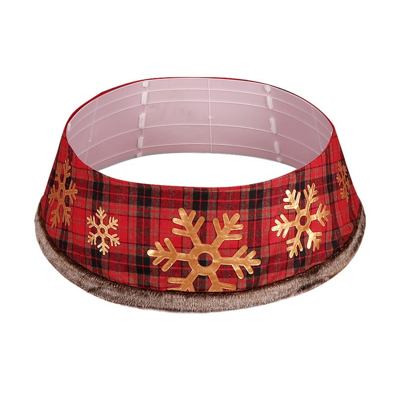 Christmas tree skirt close-up showing plaid pattern and delicate snowflake details