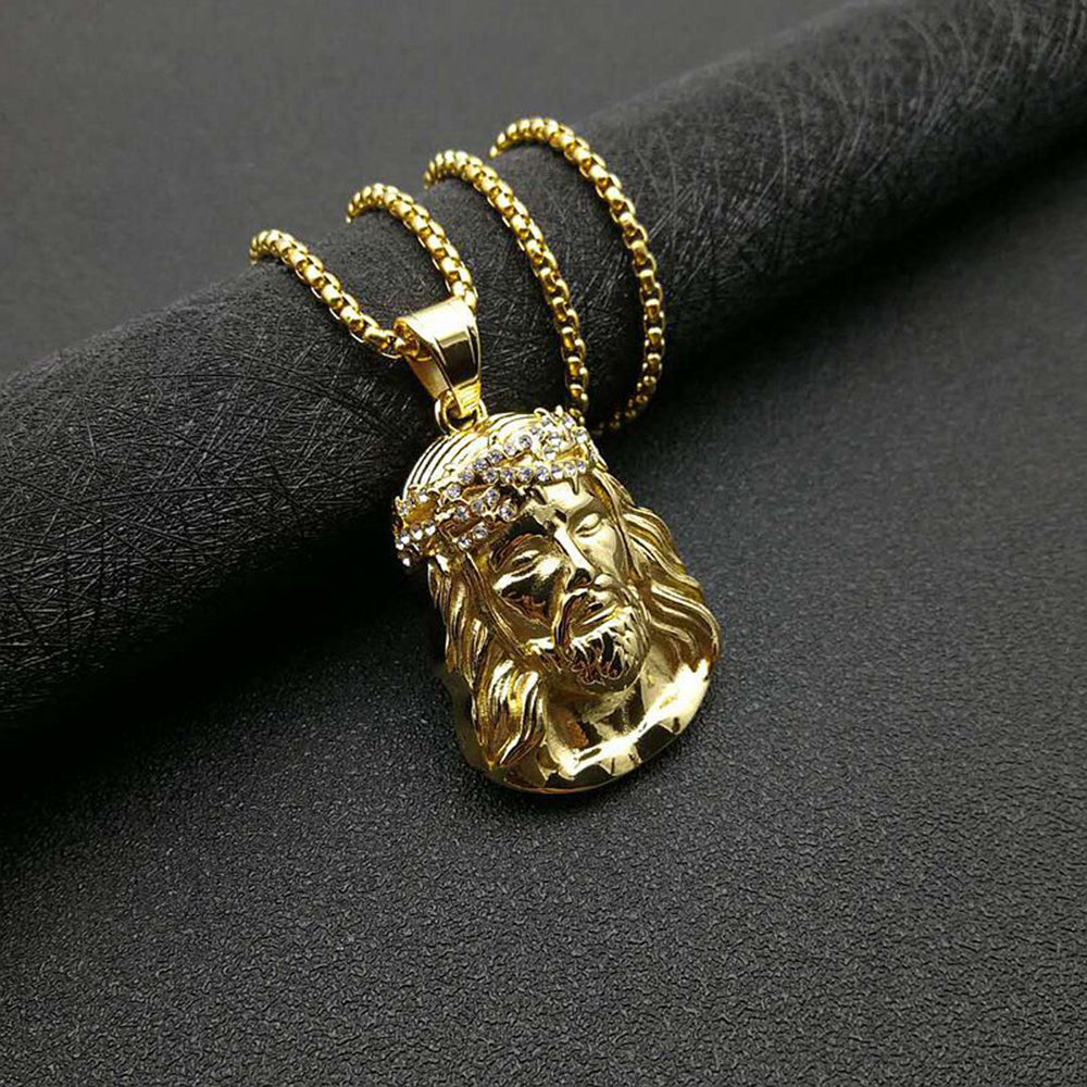 Hip-hop style gilded pendant on golden chain, close-up detail