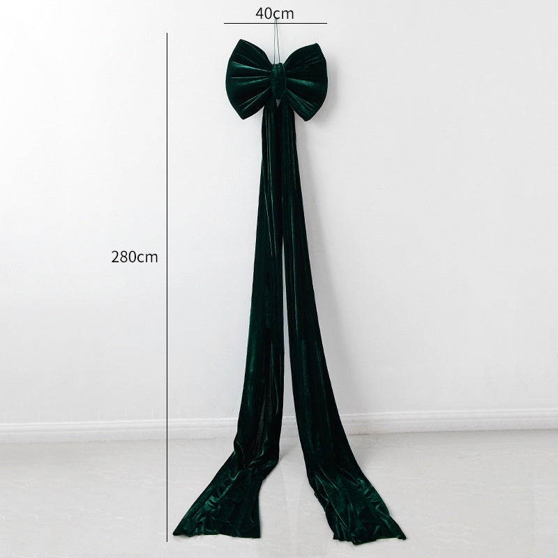 Large velvet Christmas bow decoration in rich red tones for holiday display