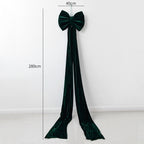 Large velvet Christmas bow decoration in rich red tones for holiday display