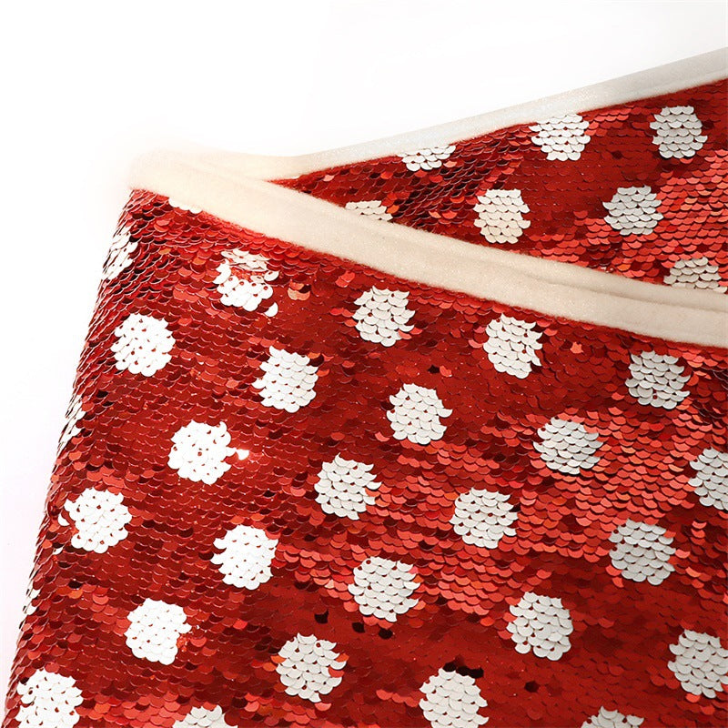Red and white dot sequins Christmas tree skirt draped around tree base Main image