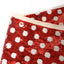 Red and white dot sequins Christmas tree skirt draped around tree base