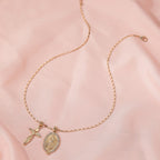 Gold-tone cross necklace with Virgin Mary crystal centerpiece