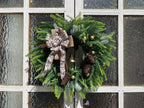 Traditional Christmas wreath with pine cones for seasonal front door display