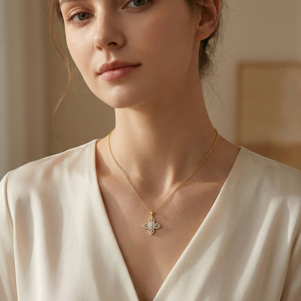 Elegant floral cross pendant necklace with marquise and baguette crystal accents on adjustable silver chain