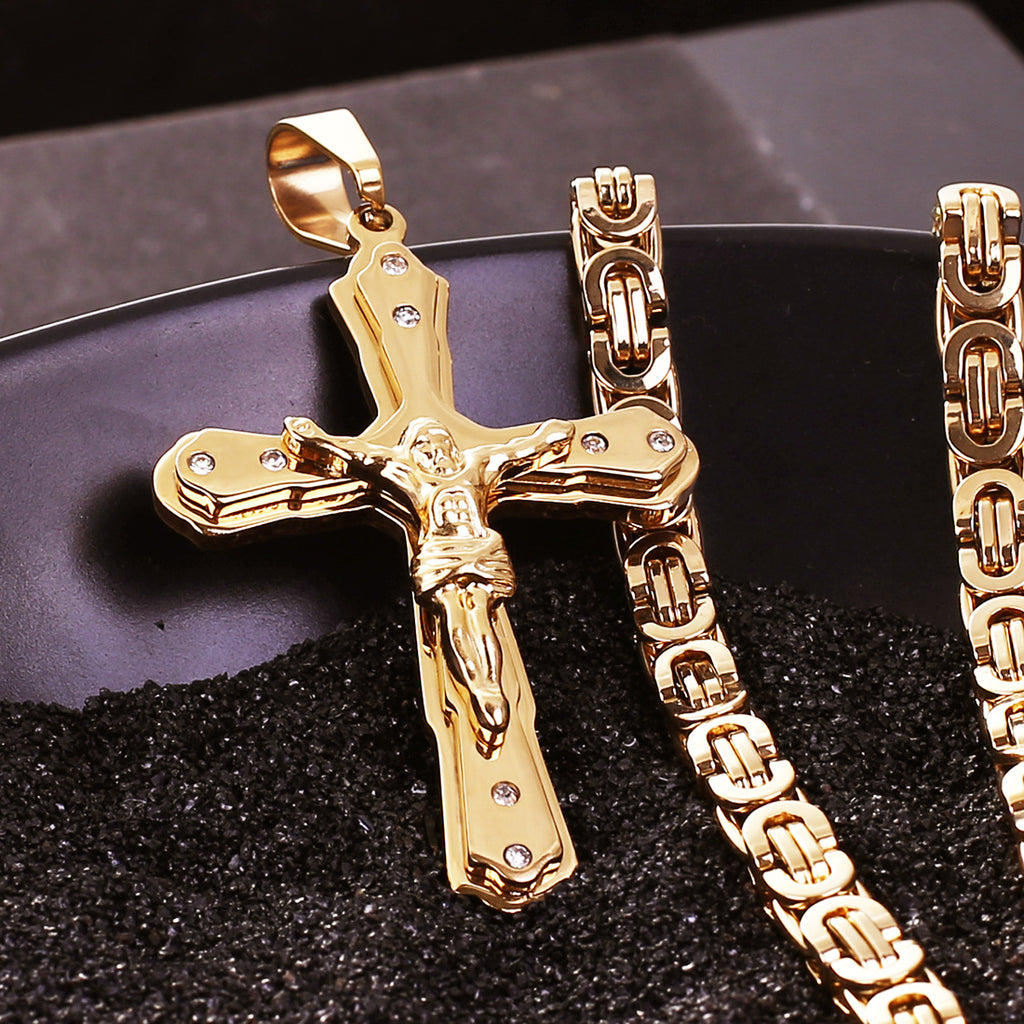 Close-up of polished golden cross pendant showing geometric design and warm finish
