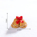 Colorful resin gingerbread man ornament displayed on a decorated Christmas tree