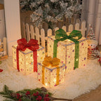 Three Christmas gift boxes with bows in small medium large sizes glowing
