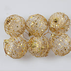 Gold-tone scaly Christmas ball ornament displayed prominently for faith-based holiday gifting