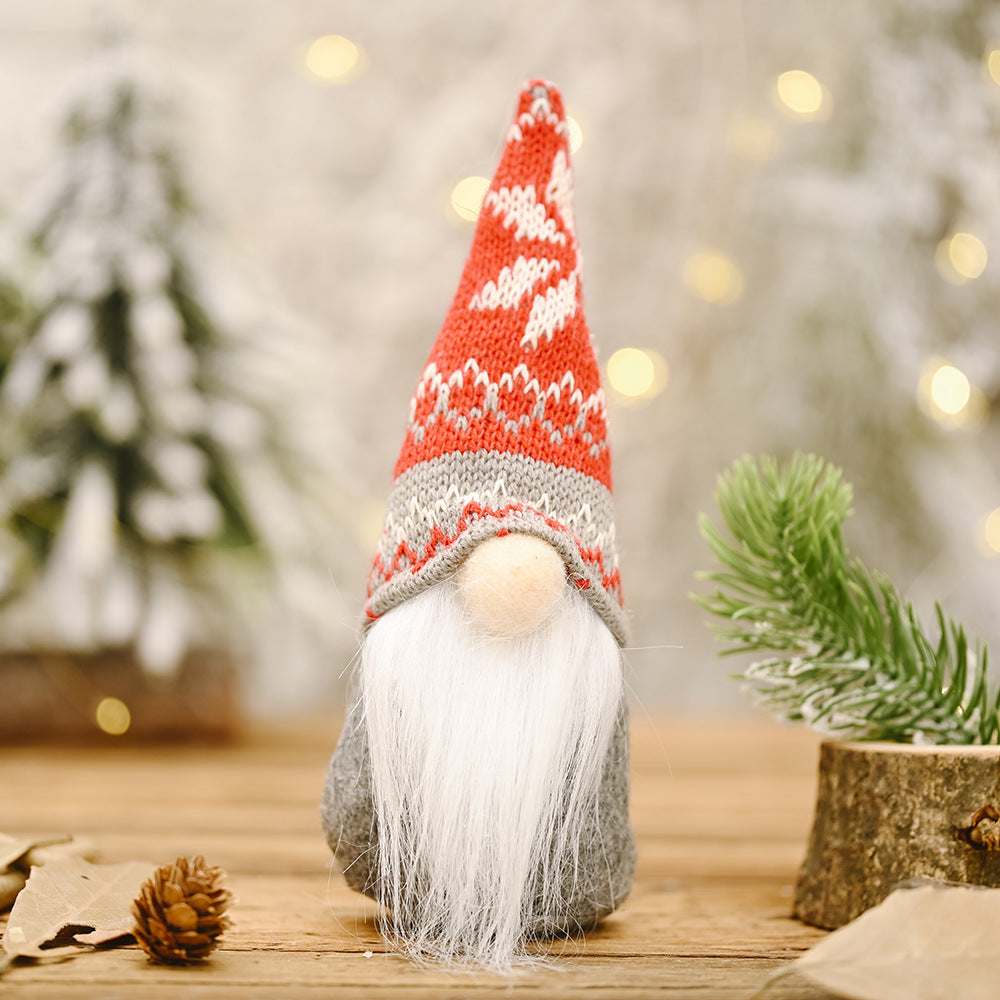 Forest doll ornaments arranged in festive Christmas gift box with ribbon