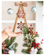 Wooden Christmas tree ornament with floral accents and gentle lighting chain detail