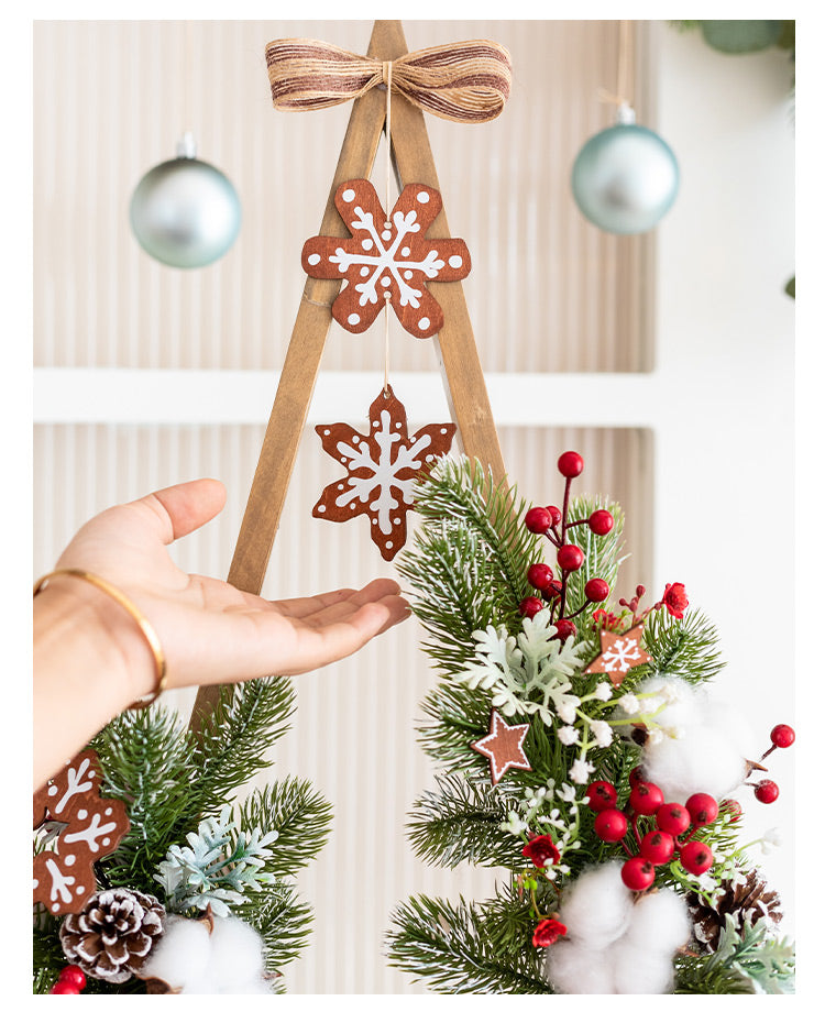 Wooden Christmas tree ornament with floral accents and gentle lighting chain detail