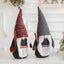 Christmas Rudolf ornament with gray clothes displayed against a festive background