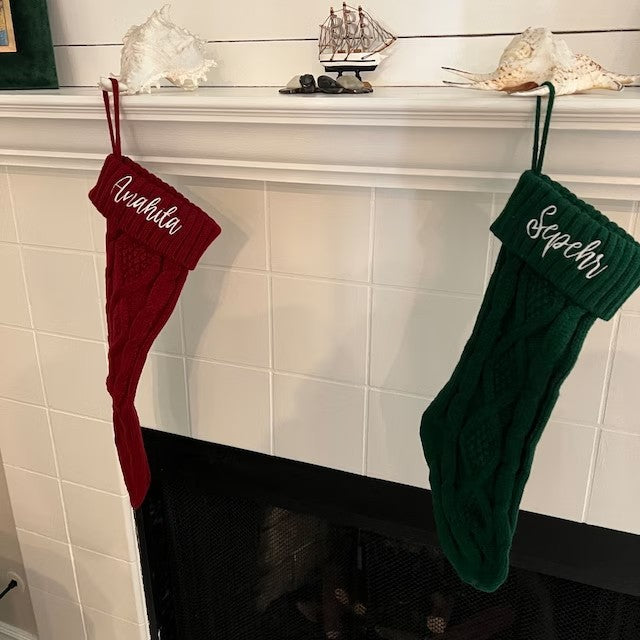 Set of colorful knitted Christmas gift bags arranged on holiday mantel display