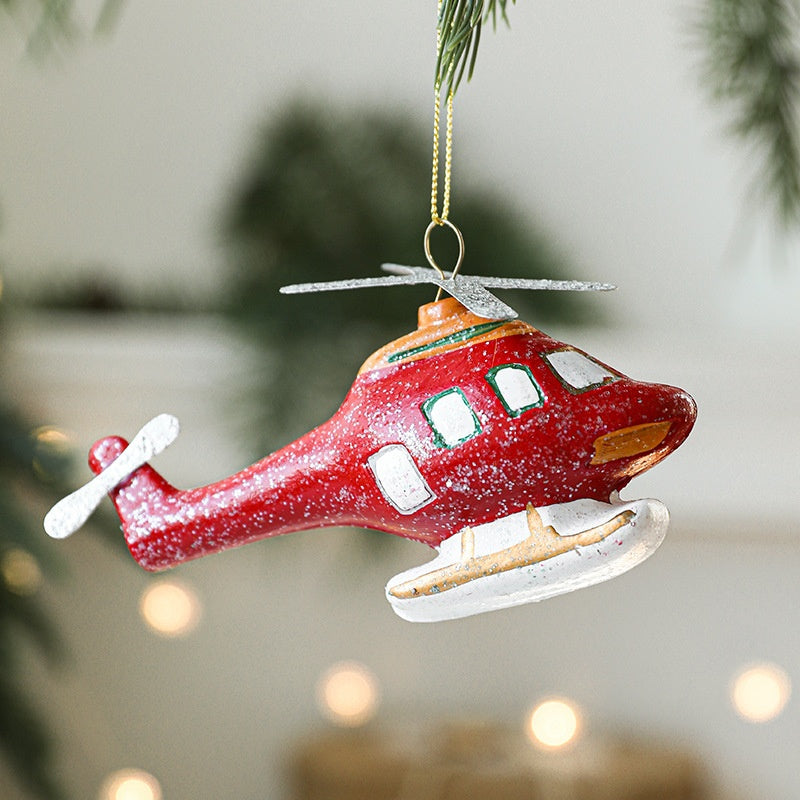 Colorful painted plastic Christmas snowman ornament hanging on tree branch