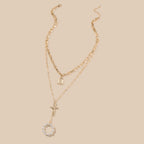 Close-up of detailed cross pendant on golden lattice necklace chain