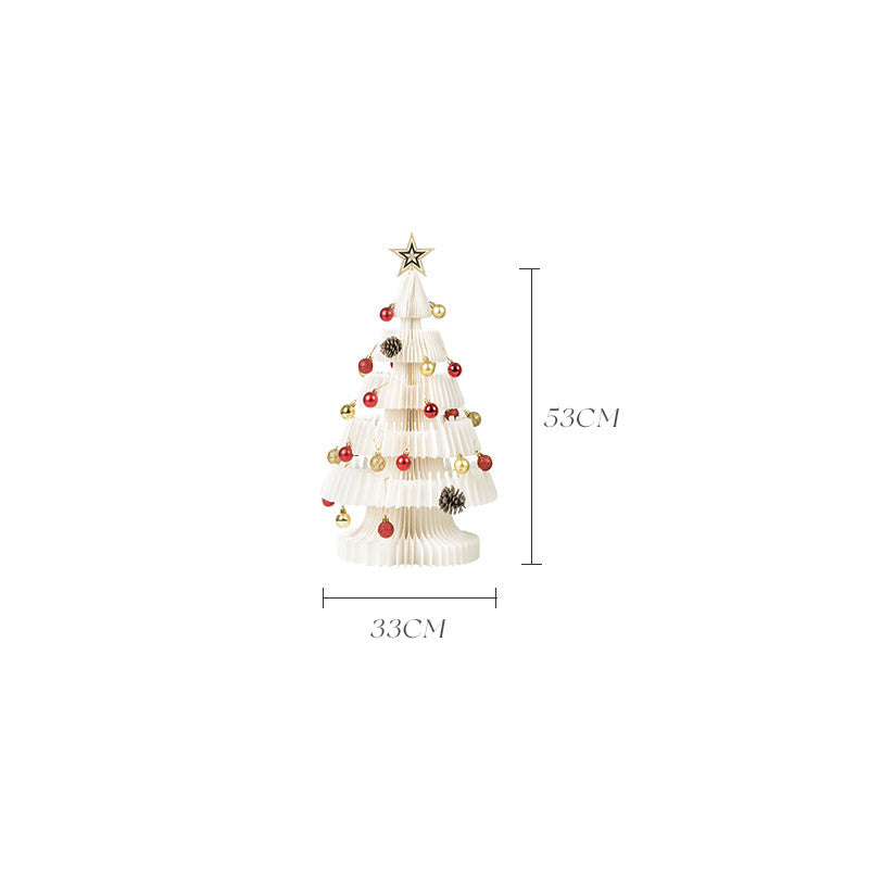 Paper origami Christmas tree arranged with other holiday decorations