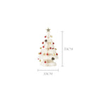 Paper origami Christmas tree arranged with other holiday decorations