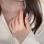 Close-up view of delicate faith ring featuring cross and heart symbols