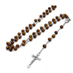 Close-up of red wooden beads on round chain rosary necklace