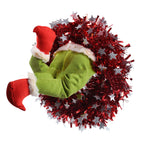 Green prosthetic leg shaped Christmas ornament hanging on tree