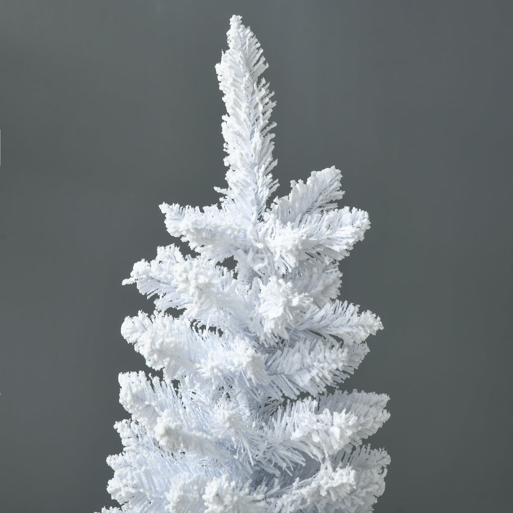 White pencil Christmas tree standing next to a fireplace with holiday decorations