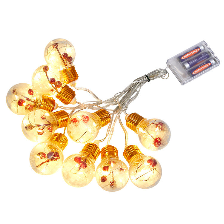 Red fruit Christmas light string with green pine needle accents for seasonal decorating