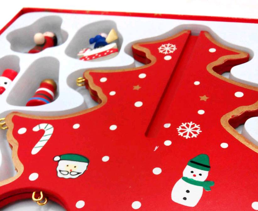 Close-up of hand-painted details on wooden Christmas tree decoration