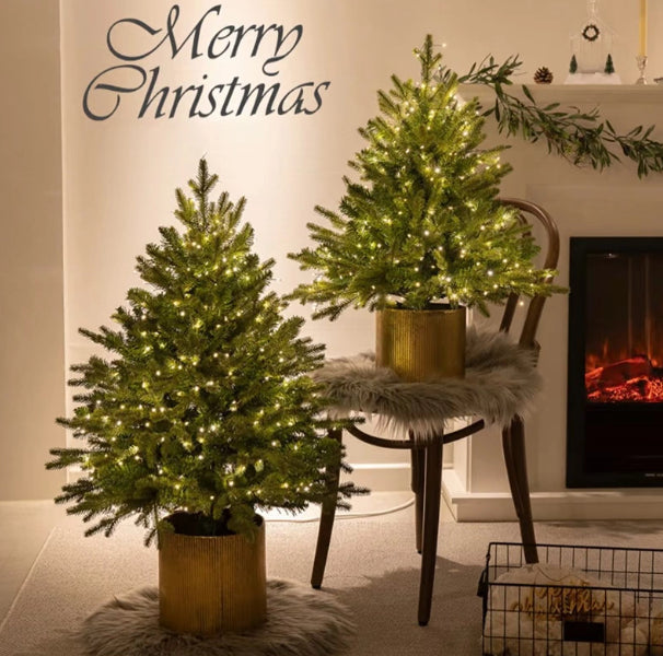 45CM Christmas tree decoration with 100 warm white lights glowing in festive setting
