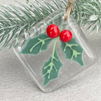 Set of glass Christmas pendants catching warm light