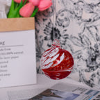 Hand-blown glass Christmas bauble with warm ambient lighting