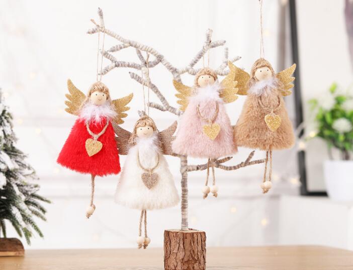 Angel tree pendant displayed among festive Christmas greenery and ribbons