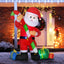 Inflatable Santa Claus Christmas yard decoration with LED lights standing in snowy yard