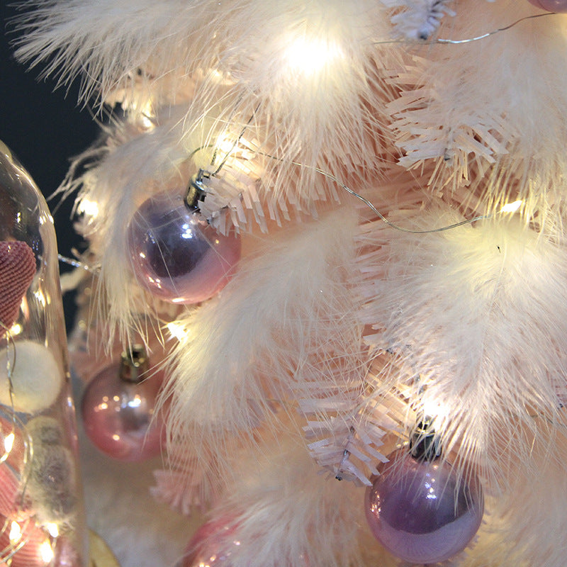 Christmas tree ornament with LED lights and pink feathers