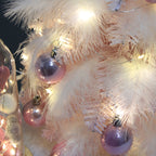 Christmas tree ornament with LED lights and pink feathers