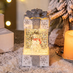 Small Christmas tree decoration featuring light-up gift box in red