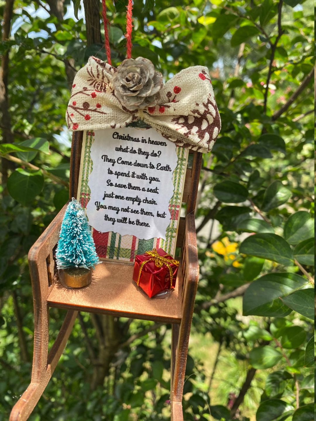 Heaven Chair ornament displayed among evergreen branches and ornaments