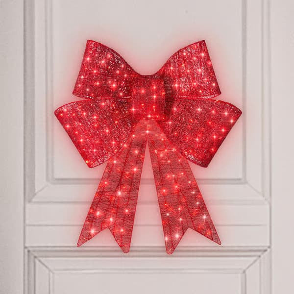 Close-up view of glowing red satin bowknot for Christmas decor