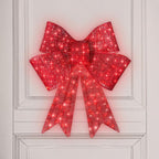 Close-up view of glowing red satin bowknot for Christmas decor