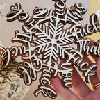 Wooden snowflake letter pendant displayed as Christmas tree ornament with warm holiday ambiance